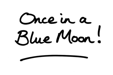Once in a Blue Moon! handwritten on a white background.の写真素材