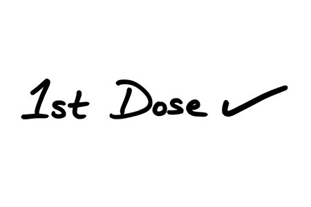 1st Dose with a Tick, handwritten on a white background.の写真素材