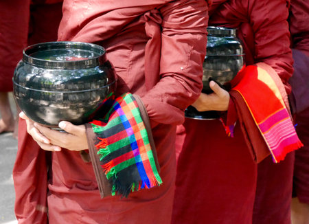 Close up Burmese novices with alms bowls, from shoulders down, Myanmarの写真素材