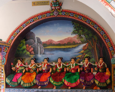 Close up of row of colourful female figurines, Hindu temple, Singapore