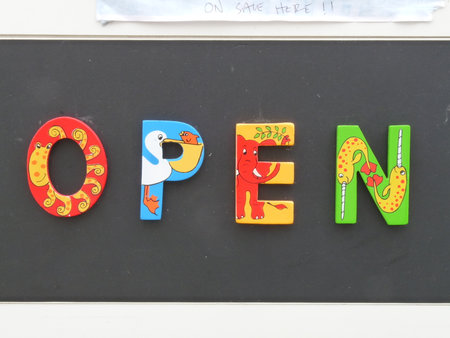 Colourful open sign with animals in shop window, Falmouth, Cornwall
