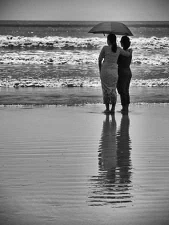 Monochrome two female friends looking out to sea, Setse beach, Myanmar. High quality photoの写真素材