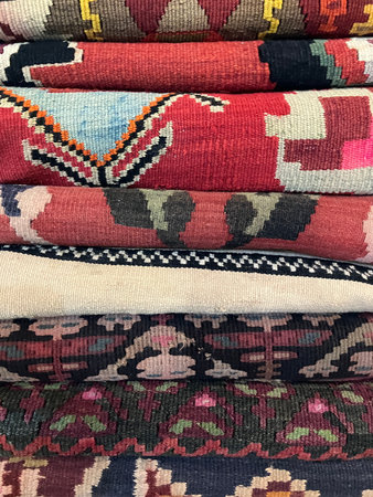 Pile of colourful, hand-made cloths on sale in shop, Tbilisi, Georgia