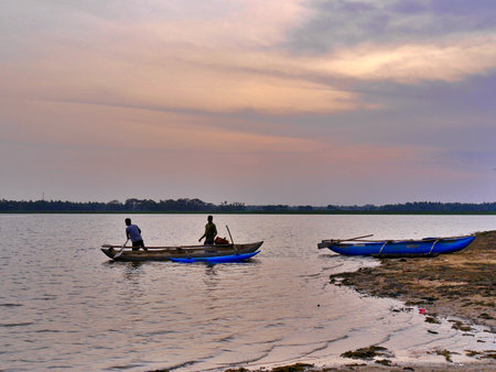Men in boats on lake at sunset, Tissamarahama, Sri lanka. High quality photo
