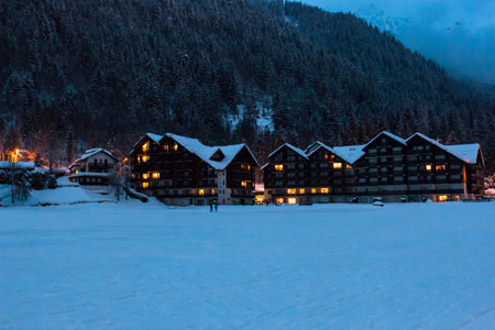 Beautiful chalets by night in the middle of the Alps. Snowing time.のeditorial素材