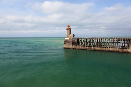 Lighthouse in Normandy surrounded by green seaの写真素材