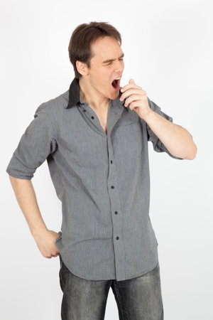 handsome man doing different expressions in different sets of clothes: yawningの写真素材