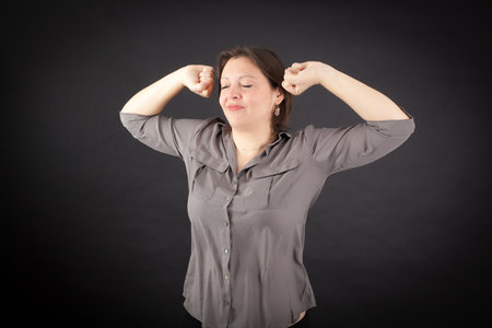 Beautiful woman doing different expressions in different sets of clothes: wake upの写真素材