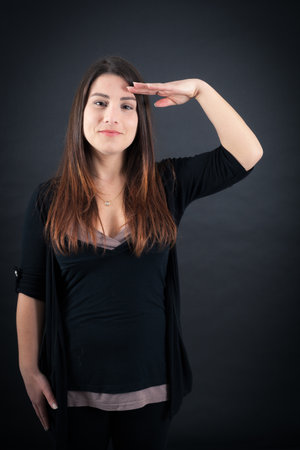 Beautiful woman doing different expressions in different sets of clothes: at attention