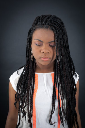 Beautiful girl doing different expressions in different sets of clothes: sadの写真素材