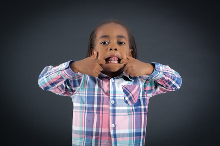 Handsome boy doing different expressions in different sets of clothes: making a afceの写真素材