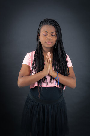 Beautiful girl doing different expressions in different sets of clothes: prayerの写真素材