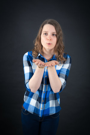 Beautiful woman doing different expressions in different sets of clothes: kissの写真素材