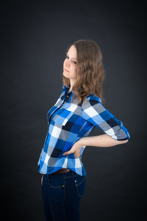 Beautiful woman doing different expressions in different sets of clothes: backacheの写真素材