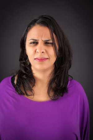 Beautiful woman doing different expressions in different sets of clothes: angryの写真素材