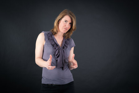 Beautiful woman doing different expressions in different sets of clothes: gun signの写真素材