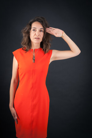Beautiful woman doing different expressions in different sets of clothes: at attentionの写真素材