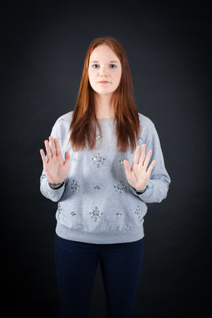 Beautiful woman doing different expressions in different sets of clothes: stop sign