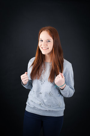 Beautiful woman doing different expressions in different sets of clothes: arms raised