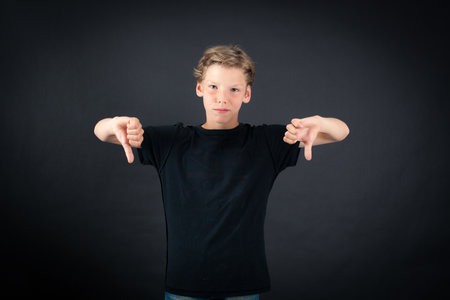 Handsome boy doing different expressions in different sets of clothes: thumbs downの写真素材