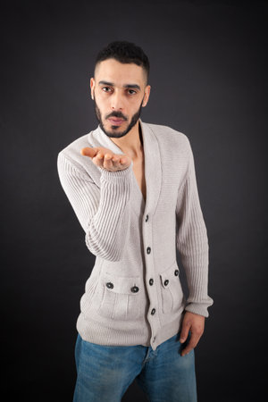 Handsome man doing different expressions in different sets of clothes: kissの写真素材