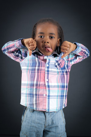 Handsome boy doing different expressions in different sets of clothes: thumbs downの写真素材