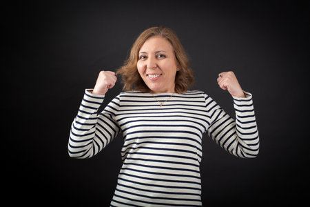 Beautiful woman doing different expressions in different sets of clothes: arms raised