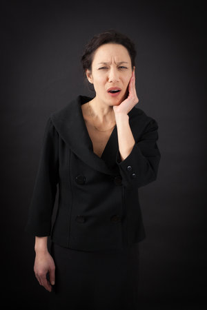 beautiful woman doing different expressions in different sets of clothes: toothacheの写真素材