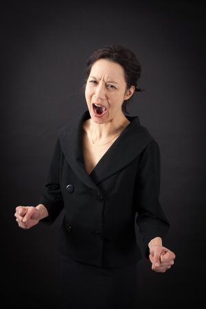 beautiful woman doing different expressions in different sets of clothes: angryの写真素材