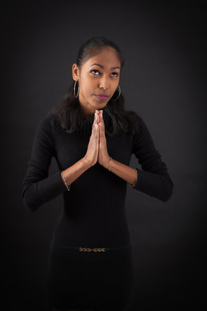 beautiful woman doing different expressions in different sets of clothes: prayerの写真素材