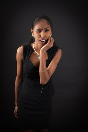 beautiful woman doing different expressions in different sets of clothes: toothacheの写真素材
