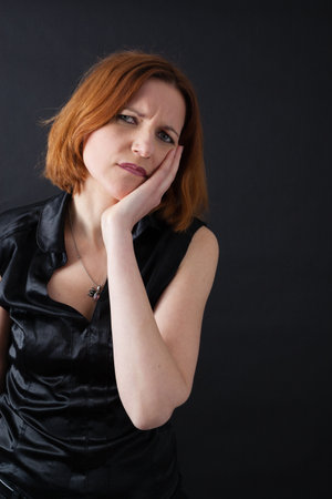 Beautiful woman doing different expressions in different sets of clothes: toothacheの写真素材