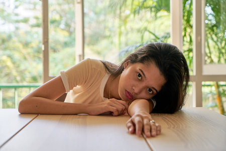 Beautiful woman posing - sitting and tiredの写真素材