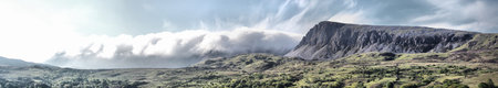 Majestic Cadair Idris mountain range shrouded in cloud