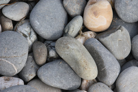 stones and roccks on a sandy beach backgroundの写真素材