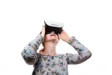 Girl use VR mobile game application with innovative 3D vr headset.Trendy augmented reality gadget.Play VRの写真素材