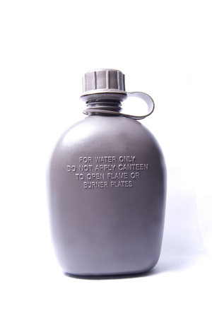 An olive drab military water canteen isolated on a white backgroundの写真素材