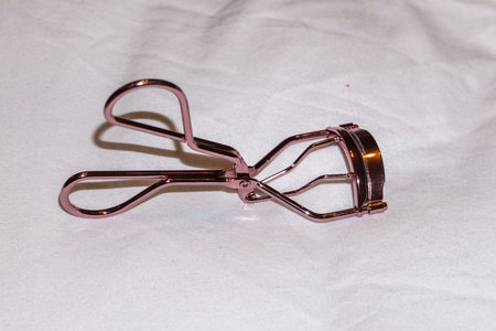 Eyelash curler on white ground in roseの写真素材