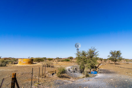 A windmill and water reservoir in Namibia.の写真素材