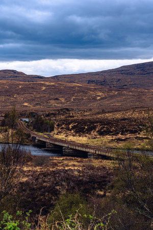 Old rail bridge spanning over a highland loch in Scotlandの写真素材