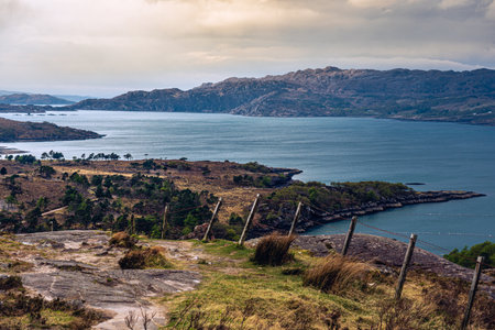 hiking fence mountains lake dramatic sky scotland