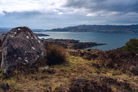 rock stones mountains lake landscape clouds scotlandの写真素材