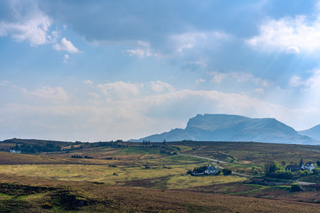 Houses near the bridge of Isle of Skye with dark clouds and sunbeams.の写真素材