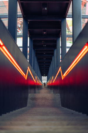 stairs with boarding and orange lit converging lines in Zollverein, an industrial heritage site in Essen, Germany, a former coal mineの写真素材