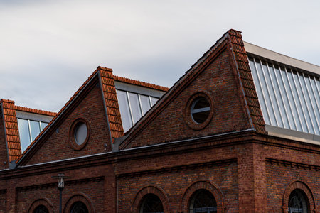 Brand new red rooftop with glas against clouds and skyの写真素材