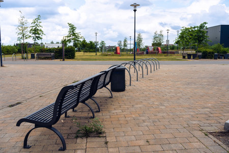 Empty bicycle parking city park with yellow bench on the background.の写真素材