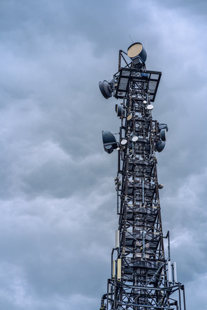 Satellite Dish on Telecommunication Radio antenna Tower with blue skyの写真素材