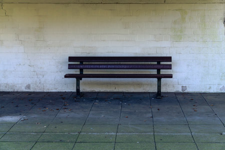 New dirty wooden bench in the city covered with mud and dirtの写真素材