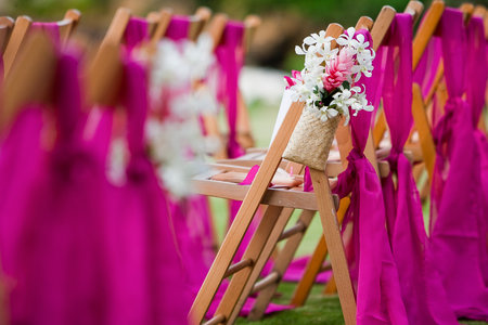 White Dendrobium Orchid and Pink Ginger flowers on a wedding aisle for a destination weddingの写真素材