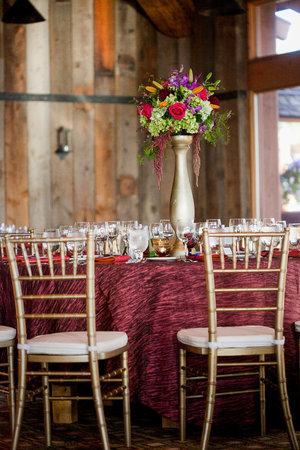 Centerpieces made of Roses, Asparagus fern, Delphinium, Asiatic lilies, Wax flower, Amaranthus, and Springeri at a wedding receptionの写真素材
